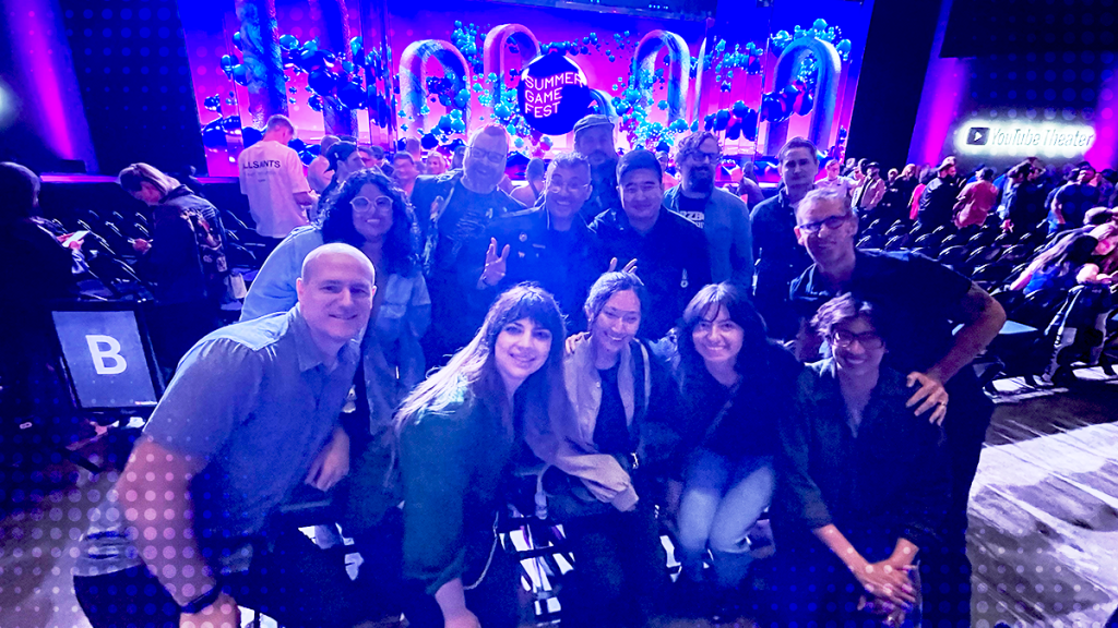 The Off Base team at Summer Game Fest, posing in front of the vibrant main stage at YouTube Theater.
